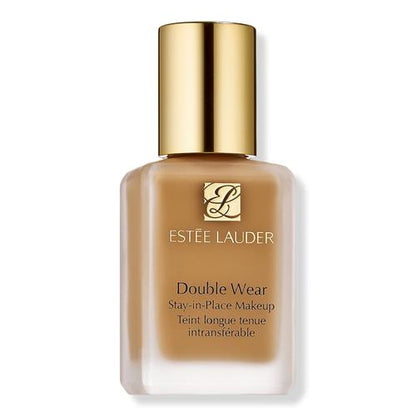 Estée Lauder Double Wear Stay-in-Place Makeup foundation bottle with a gold cap and a warm tan-brown liquid visible through the frosted glass, on a white background.
