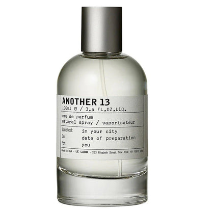 A 100ml bottle of LE LABO Another 13 Eau de Parfum, featuring a clear glass bottle with a silver metallic cap and a minimalist white label with black text, set against a plain white background.