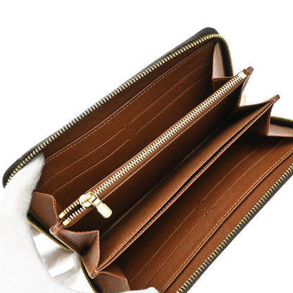 Brown wallet with gold zipper on a white background