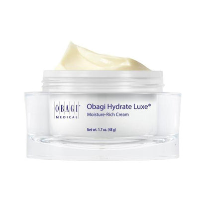 A jar of Obagi Medical Obagi Hydrate Luxe Moisture-Rich Cream with a swirl of pale yellow cream visible at the top, set against a plain white background.