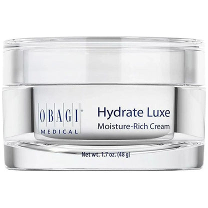 A clear cosmetic jar of Obagi Medical Hydrate Luxe Moisture-Rich Cream with a white label and silver-toned base, shown on a white background.